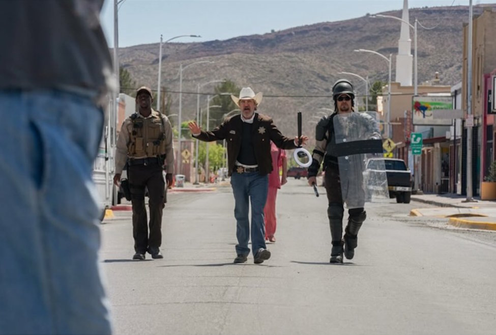 A still of Troy Cross (Pedro Pascal) in Ari Aster's "Eddington," walking during a showdown, as reviewed by Ezekiel Yu.